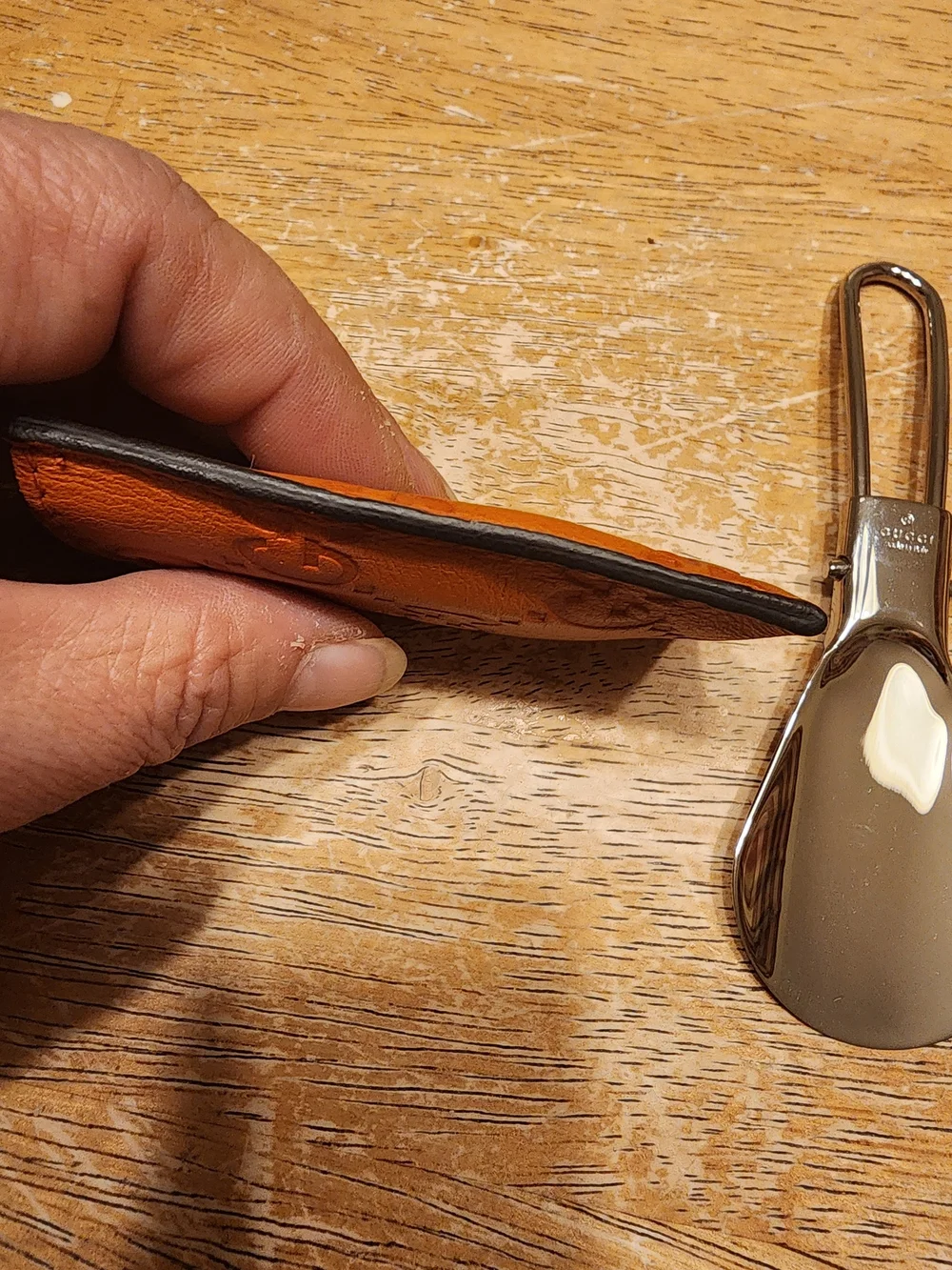 vintage Gucci portable metal shoehorn housed in an embossed brown Guccissima GG